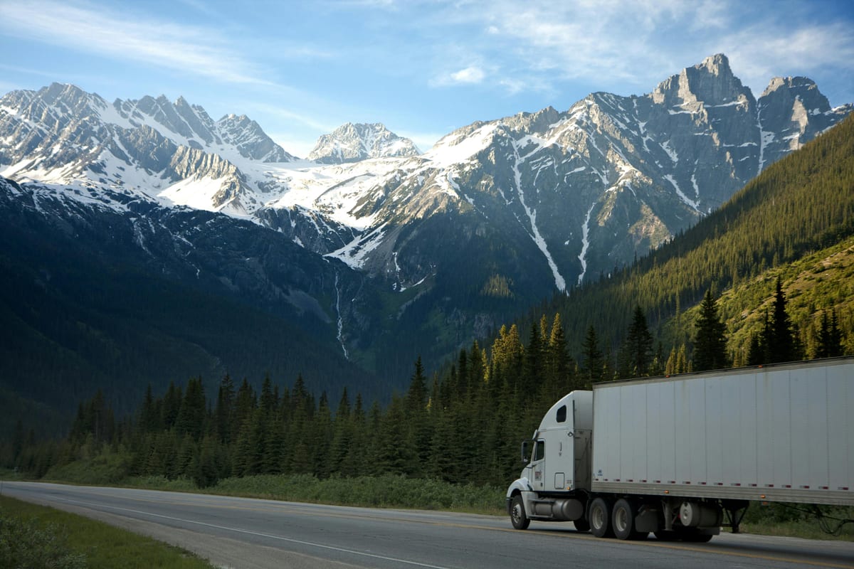 Modern American freight tractor on an interstate corridor at sunrise, representing dry van full truckload capacity