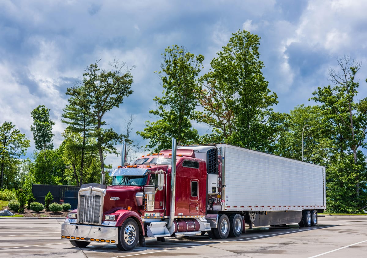 Modern refrigerated trailer at a temperature-controlled distribution facility, representing cold chain freight capacity